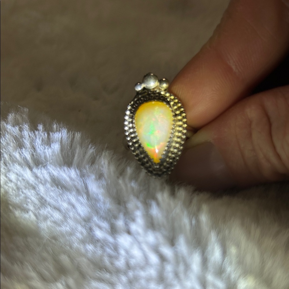 Firey Ethiopian opal ring with elaborate setting